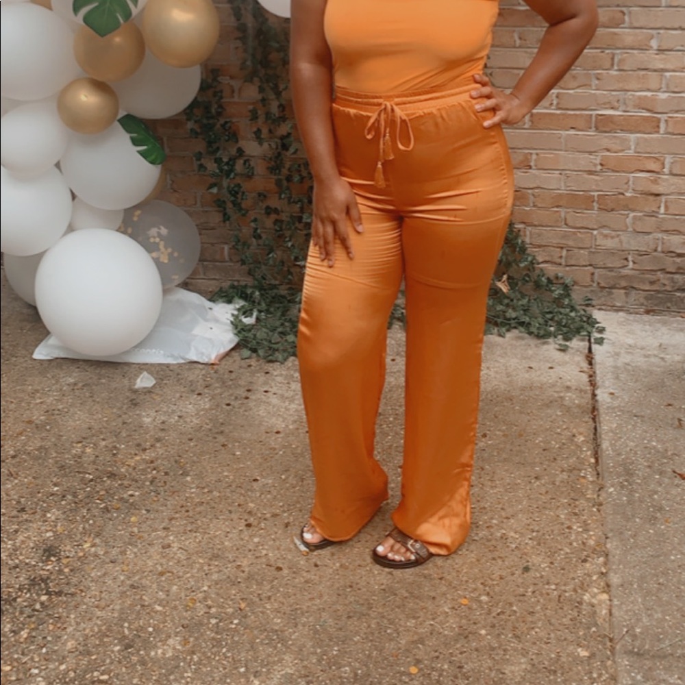 Orange silk flare pants with tassel drawstring
